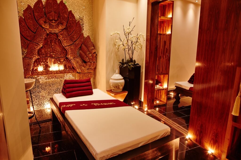 Thai Square Spa treatment room in London with warm lighting and luxurious setting for spring spa day